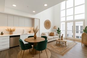 Los Angeles apartment for rent - A modern kitchen with a dining table and chairs at Fusion Hollywood Apartments.