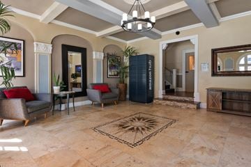 Pasadena apartment for rent - A living room with a rug in the middle and a chandelier hanging from the ceiling.