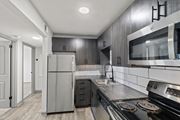 Nashville apartment for rent - The Canvas Apartments modern kitchen with a stainless steel refrigerator and oven.