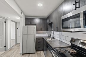 Nashville apartment for rent - The Canvas Apartments modern kitchen with a stainless steel refrigerator and oven.
