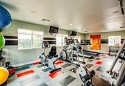 Las Vegas apartment for rent - A gym with a variety of exercise equipment including treadmills, stationary bikes, and weight machines.