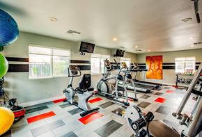 Las Vegas apartment for rent - A gym with a variety of exercise equipment including treadmills, stationary bikes, and weight machines.
