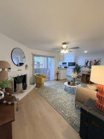 Fort Worth townhouse for rent - A living room with a fireplace, a yellow chair, and a rug.