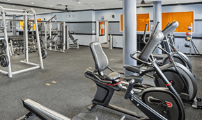 Los Angeles apartment for rent - Fusion Encore Hollywood fitness center with a row of exercise bikes and weightlifting equipment.