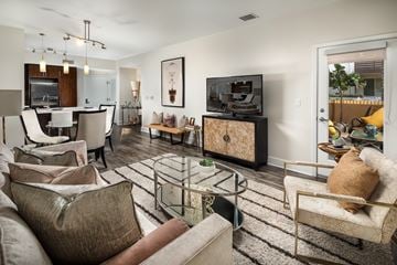 Los Angeles apartment for rent - A living room with a brown couch and a glass coffee table.