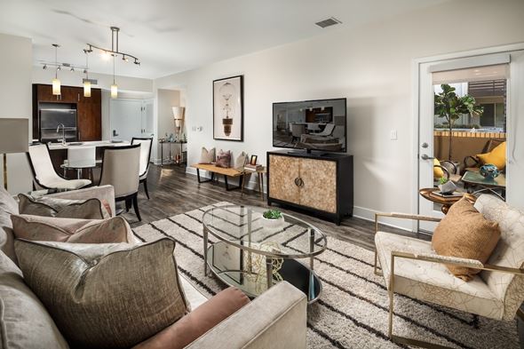 Los Angeles apartment for rent - Fusion Encore Hollywood Apartments living room with a brown couch and a glass coffee table.