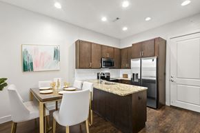 Nashville apartment for rent - State Street Flats Apartments near Vanderbilt University Nashville TN modern kitchen with a dining table set for two.