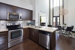 Los Angeles apartment for rent - Fusion Encore Hollywood Apartments modern kitchen with dark wood cabinets and stainless steel appliances.
