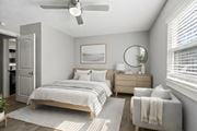 Jacksonville apartment for rent - A bedroom with a bed, dresser, and chair at Mandarin Bay Apartments.