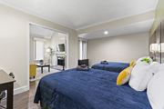 Orlando apartment for rent - Fusion Orlando furnished bedroom with two large beds and an opening to the living room.
