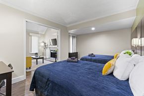 Orlando apartment for rent - Fusion Orlando furnished bedroom with two large beds and an opening to the living room.