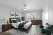 Lakeland apartment for rent - A bedroom with a bed, nightstand, and chair at Watermarc Apartments.