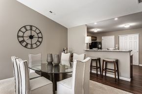 Reynoldsburg townhouse for rent - Wheaton Ridge dining room table surrounded by six chairs, next to a. kitchen.
