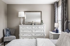 Blacklick townhouse for rent - Spacious bedroom with a large dresser and mirror, perfect for personal touches
