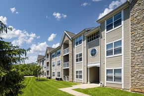 Etna apartment for rent - Apartments for Rent in Pickerington, OH - Arbors at Turnberry - Apartment Building Exterior with Lush Landscaping