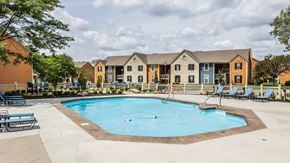 Westerville apartment for rent - A swimming pool surrounded by chairs and concrete at Fairway Lakes in Westerville, OH.