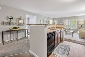 Delaware townhouse for rent - A kitchen with a black oven and a dining table with chairs.