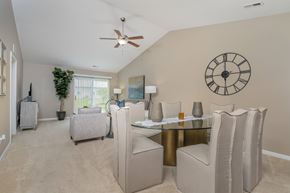 Blacklick townhouse for rent - A dining room with a glass table and chairs.