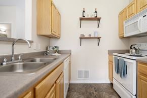Pataskala apartment for rent - A kitchen with a white oven and a white microwave.