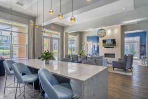 Miamisburg apartment for rent - A modern dining room with a long table and grey chairs.