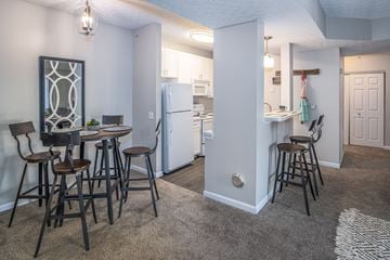 Etna apartment for rent - A kitchen with a table and chairs in the foreground and a refrigerator in the background.