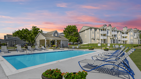 Florence apartment for rent - Resort-style pool at The Boulevard in Florence, KY with a sundeck, lush landscaping, and lounge seating