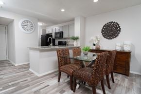 Dublin apartment for rent - Renovated dining area at Britton Woods featuring granite counters, wood-style floors, and stainless steel appliances
