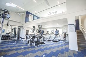 Canal Winchester apartment for rent - A gym with a variety of equipment including treadmills, weights, and exercise machines.