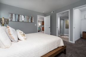 Delaware townhouse for rent - Modern bedroom with gray walls and a large white bed for a calm, neutral palette