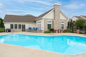 Delaware townhouse for rent - Delaware, OH Apartments Near Tanger Outlets - Carson Farms - Swimming Pool Surrounded By Patio Furniture, BBQ Area, and Lush Landscaping