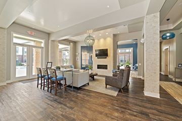 Miamisburg apartment for rent - a spacious living room with a dining room table and a fireplace