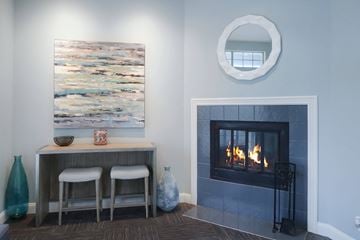 Florence apartment for rent - a living room with a fireplace and a table with two stools