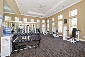 Florence apartment for rent - Fitness center in Florence, KY, with workout machines, weights, and windows.