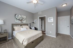 Florence apartment for rent - A furnished bedroom at Trellises with carpeted flooring, next to a bathroom.