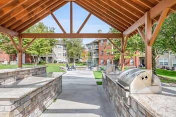 Outdoor kitchen with gas grills and fire pit