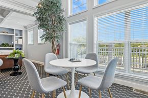 Indianapolis apartment for rent - A dining room with a white table and grey chairs.