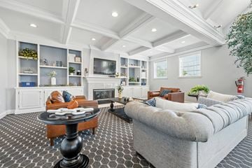 Indianapolis apartment for rent - A living room with a grey couch and a black and white checkered floor.