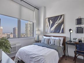 New Brunswick apartment for rent - a bedroom with a bed and a large window