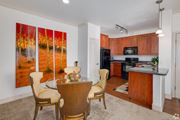 Queen Creek apartment for rent - A dining room with a table set for two and a painting of a forest scene on the wall.