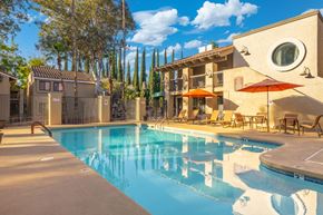Tucson apartment for rent - A pool with a building behind it.