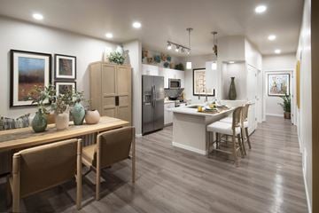 Tucson apartment for rent - A modern kitchen with wooden chairs and a dining table.