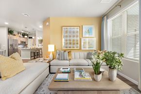 Marana apartment for rent - A living room with a grey sofa, a coffee table, and a yellow pillow.