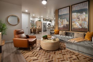 Tucson apartment for rent - A living room with a brown leather chair and a grey couch.