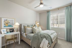 Marana apartment for rent - A bedroom with a bed, desk, chair, and window.