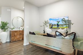 Marana apartment for rent - A bedroom with a bed, a mirror, a painting, and a plant.