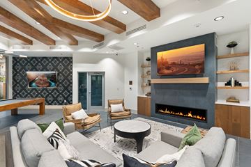 Tucson apartment for rent - A modern living room with a fireplace and a painting on the wall.