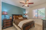 Goodyear apartment for rent - A bedroom with a bed, dresser, and ceiling fan.