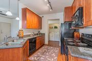 Goodyear apartment for rent - A kitchen with wooden cabinets and a black refrigerator.