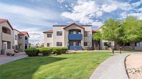 Tucson apartment for rent - grass area with sidewalk and apartment building