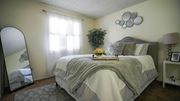 Tucson apartment for rent - A bedroom with a large bed and a mirror on the wall.